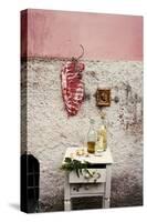Raw Pork Ribs Hanging on the Wall of a House, Next to a A Gold-Framed Picture-Maria Brinkop-Stretched Canvas