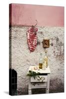 Raw Pork Ribs Hanging on the Wall of a House, Next to a A Gold-Framed Picture-Maria Brinkop-Stretched Canvas