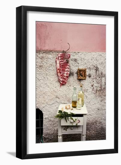 Raw Pork Ribs Hanging on the Wall of a House, Next to a A Gold-Framed Picture-Maria Brinkop-Framed Premium Photographic Print