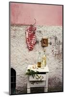 Raw Pork Ribs Hanging on the Wall of a House, Next to a A Gold-Framed Picture-Maria Brinkop-Mounted Photographic Print