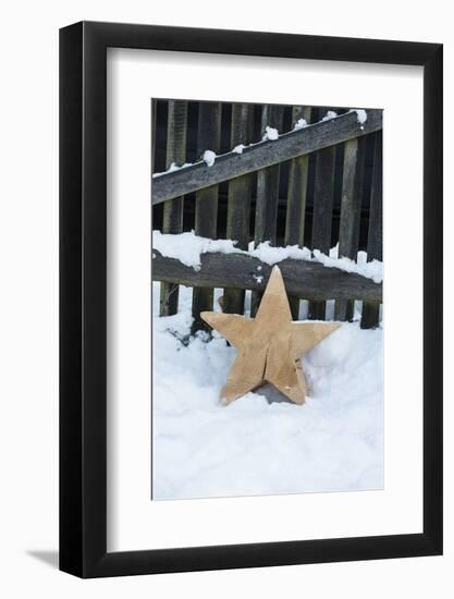 Raw Wooden Star in Front of Fence in the Snow-Andrea Haase-Framed Photographic Print
