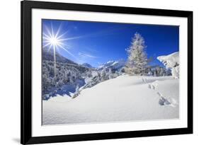 Rays of winter sun illuminate the snowy landscape around Maloja Canton of Engadine Switzerland Euro-ClickAlps-Framed Photographic Print