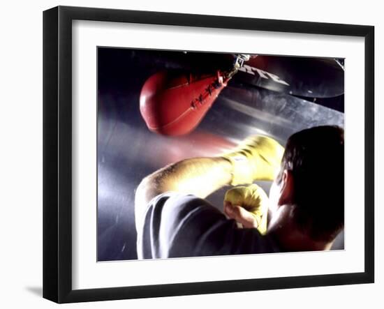 Rear View of a Boxer Punching a Punching Bag-null-Framed Premium Photographic Print