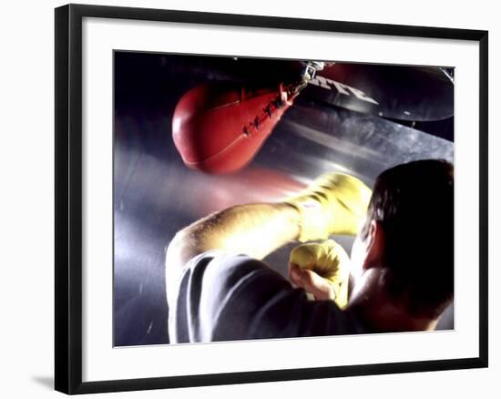Rear View of a Boxer Punching a Punching Bag-null-Framed Photographic Print