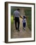 Rear View of a Man Walking with His Son at a Playing Field-null-Framed Photographic Print