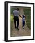 Rear View of a Man Walking with His Son at a Playing Field-null-Framed Photographic Print