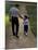 Rear View of a Man Walking with His Son at a Playing Field-null-Mounted Photographic Print