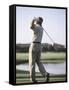 Rear View of a Senior Man Swinging a Golf Club-null-Framed Stretched Canvas