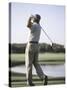 Rear View of a Senior Man Swinging a Golf Club-null-Stretched Canvas