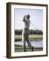 Rear View of a Senior Man Swinging a Golf Club-null-Framed Photographic Print