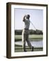 Rear View of a Senior Man Swinging a Golf Club-null-Framed Photographic Print