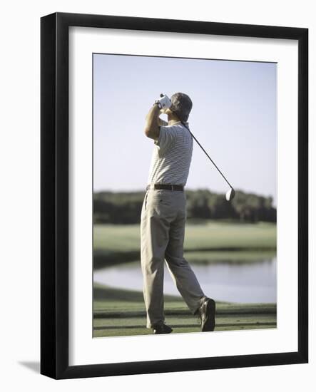 Rear View of a Senior Man Swinging a Golf Club-null-Framed Photographic Print