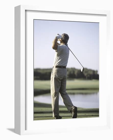 Rear View of a Senior Man Swinging a Golf Club-null-Framed Photographic Print