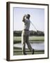 Rear View of a Senior Man Swinging a Golf Club-null-Framed Photographic Print