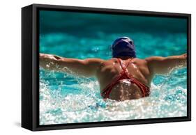 Rear view of a woman swimming the butterfly stroke in a swimming pool, Bainbridge Island, Washin...-Pete Saloutos-Framed Stretched Canvas