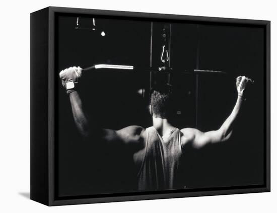 Rear View of a Young Man Exercise on a Lateral Pull-Down Weight Machine-null-Framed Stretched Canvas