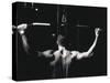 Rear View of a Young Man Exercise on a Lateral Pull-Down Weight Machine-null-Stretched Canvas