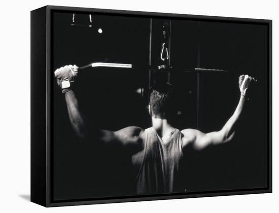 Rear View of a Young Man Exercise on a Lateral Pull-Down Weight Machine-null-Framed Stretched Canvas