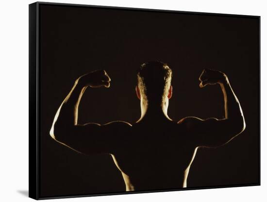 Rear View of a Young Man Flexing His Muscles-null-Framed Stretched Canvas