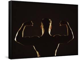 Rear View of a Young Man Flexing His Muscles-null-Framed Stretched Canvas