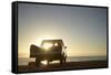 Rear View of Young Couple in Pick-Up Truck Parked in Front of Ocean Enjoying Sunset-Nosnibor137-Framed Stretched Canvas