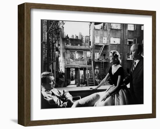 REAR WINDOW, 1954 directed byALFRED HITCHCOCK On the set, Grace Kelly between James Stewart and Alf-null-Framed Photo