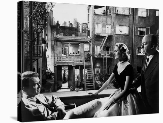 REAR WINDOW, 1954 directed byALFRED HITCHCOCK On the set, Grace Kelly between James Stewart and Alf-null-Stretched Canvas