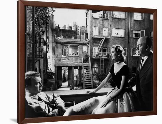 REAR WINDOW, 1954 directed byALFRED HITCHCOCK On the set, Grace Kelly between James Stewart and Alf-null-Framed Photo