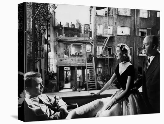 REAR WINDOW, 1954 directed byALFRED HITCHCOCK On the set, Grace Kelly between James Stewart and Alf-null-Stretched Canvas
