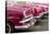 Red and pink vintage American car taxis on street in Havana, Cuba, West Indies, Central America-Ed Hasler-Stretched Canvas
