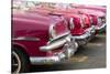 Red and pink vintage American car taxis on street in Havana, Cuba, West Indies, Central America-Ed Hasler-Stretched Canvas