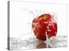 Red Apple with Splashing Water-Michael Löffler-Stretched Canvas