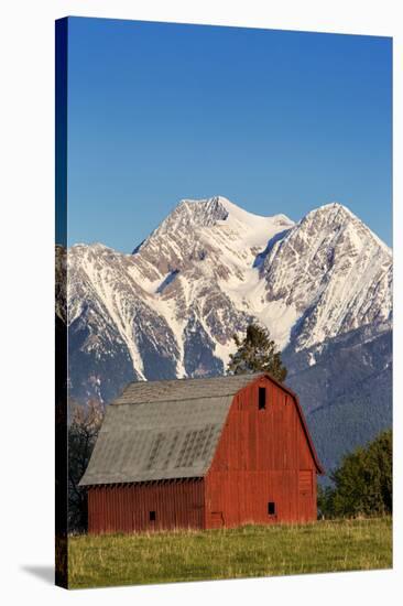 Red Barn Sits Below Mcdonald Peak in the Mission Valley, Montana, Usa-Chuck Haney-Stretched Canvas