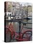 Red Bicycle by the Herengracht Canal, Amsterdam, Netherlands, Europe-Amanda Hall-Stretched Canvas