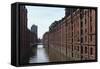 Red Brick Warehouses Overlook a Canal in the Speicherstadt District-Stuart Forster-Framed Stretched Canvas