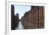 Red Brick Warehouses Overlook a Canal in the Speicherstadt District-Stuart Forster-Framed Photographic Print