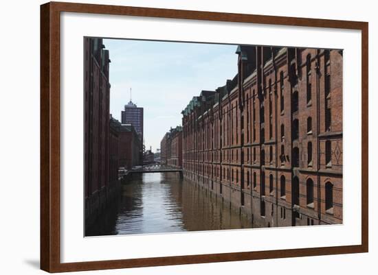 Red Brick Warehouses Overlook a Canal in the Speicherstadt District-Stuart Forster-Framed Photographic Print