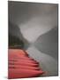 Red Canoes on Lake Louise, Banff National Park, Alberta, Canada-Walter Bibikow-Mounted Premium Photographic Print