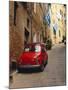 Red Car Parked in Narrow Street, Siena, Tuscany, Italy-Ruth Tomlinson-Mounted Photographic Print