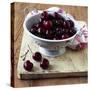 Red Cherries in a Colander on an Old Wooden Chopping Board-Michael Paul-Stretched Canvas