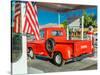 Red Dodge Pickup truck parked in front of vintage gas station in Santa Paula, California-null-Stretched Canvas