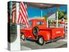 Red Dodge Pickup truck parked in front of vintage gas station in Santa Paula, California-null-Stretched Canvas