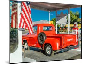 Red Dodge Pickup truck parked in front of vintage gas station in Santa Paula, California-null-Mounted Photographic Print