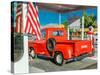 Red Dodge Pickup truck parked in front of vintage gas station in Santa Paula, California-null-Stretched Canvas