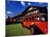 Red Jammer Buses Parked in Front of Glacier Park Lodge in East Glacier, Montana, USA-Chuck Haney-Mounted Photographic Print
