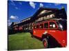 Red Jammer Buses Parked in Front of Glacier Park Lodge in East Glacier, Montana, USA-Chuck Haney-Stretched Canvas