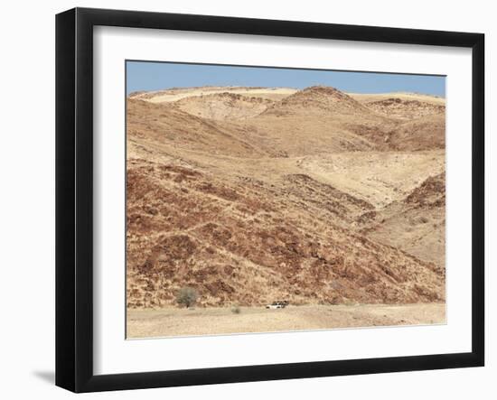 Red Rocky Landscape with Jeep in Distance, Purros Conservancy Wilderness, Kaokoland, Namibia-Kim Walker-Framed Photographic Print