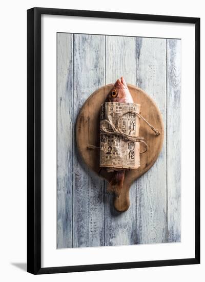 Red Snapper Wrapped in Chinese Newspaper on Wooden Background-Gary Jones-Framed Photographic Print