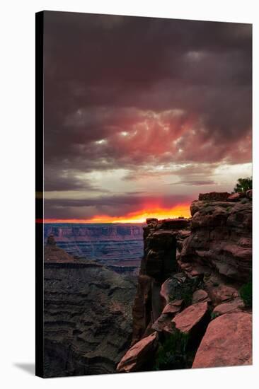 Red sunset with moody clouds and red rock canyons in Dead Horse Point State Park near Moab, Utah-David Chang-Stretched Canvas