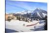 Red train of Rhaetian Railway passes in the snowy landscape of Arosa, district of Plessur, Canton o-Roberto Moiola-Stretched Canvas